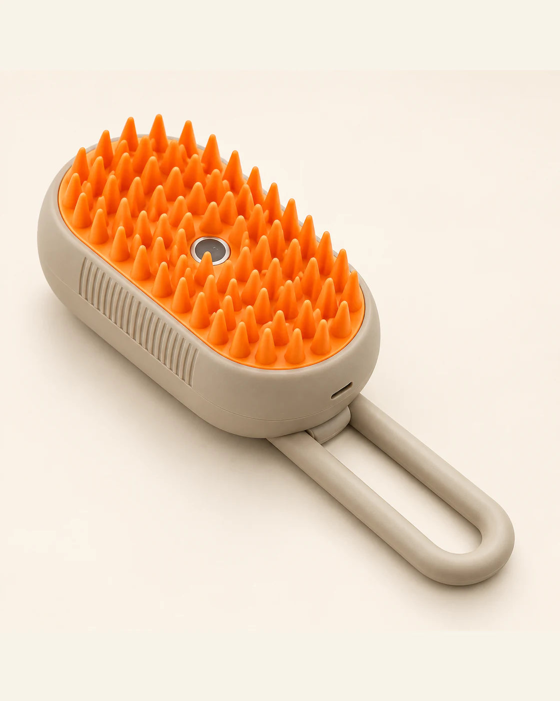 Taupe CLICK&GRAB grooming brush with orange silicone tips and an extended loop handle.