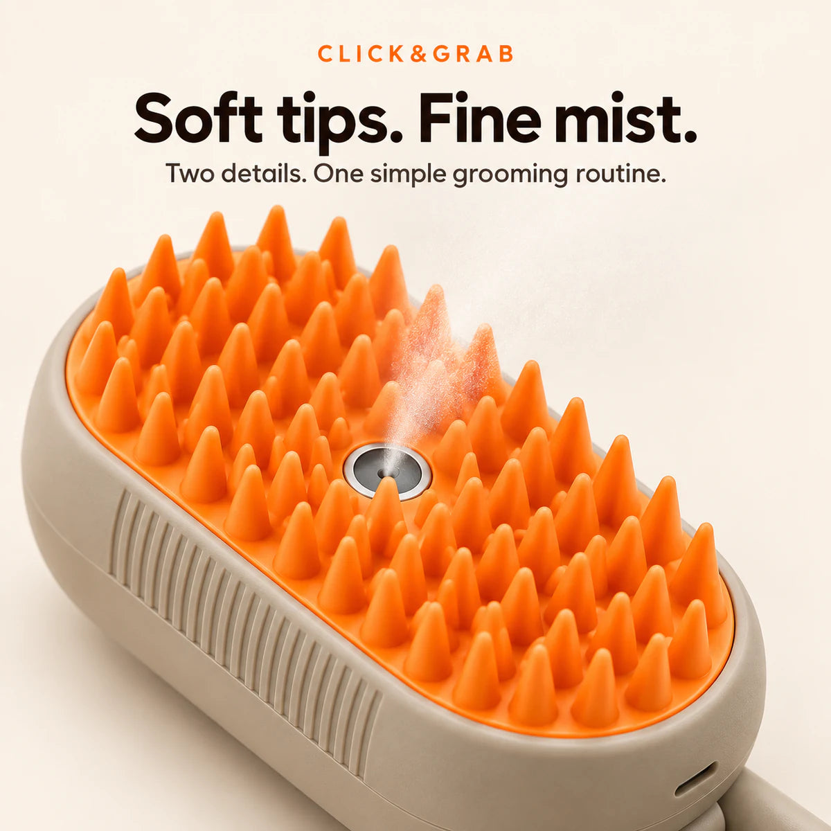 Close-up of the orange silicone tips and central fine-mist outlet on the taupe CLICK&GRAB grooming brush.